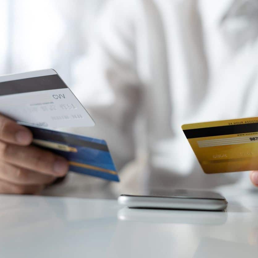 Hands choosing a credit card