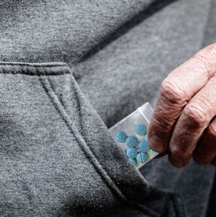fentanyl opiate in plastic bag in hand close-up