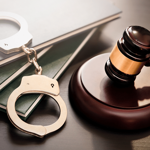 Handcuffs and wooden gavel. Crime and violence concept.