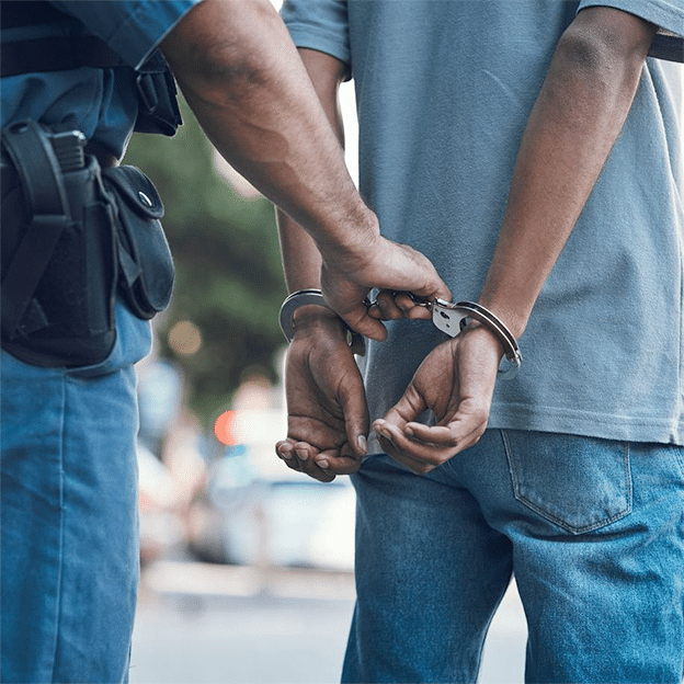 Handcuffs, police and hands of police man with criminal in city for justice, crime or corruption.